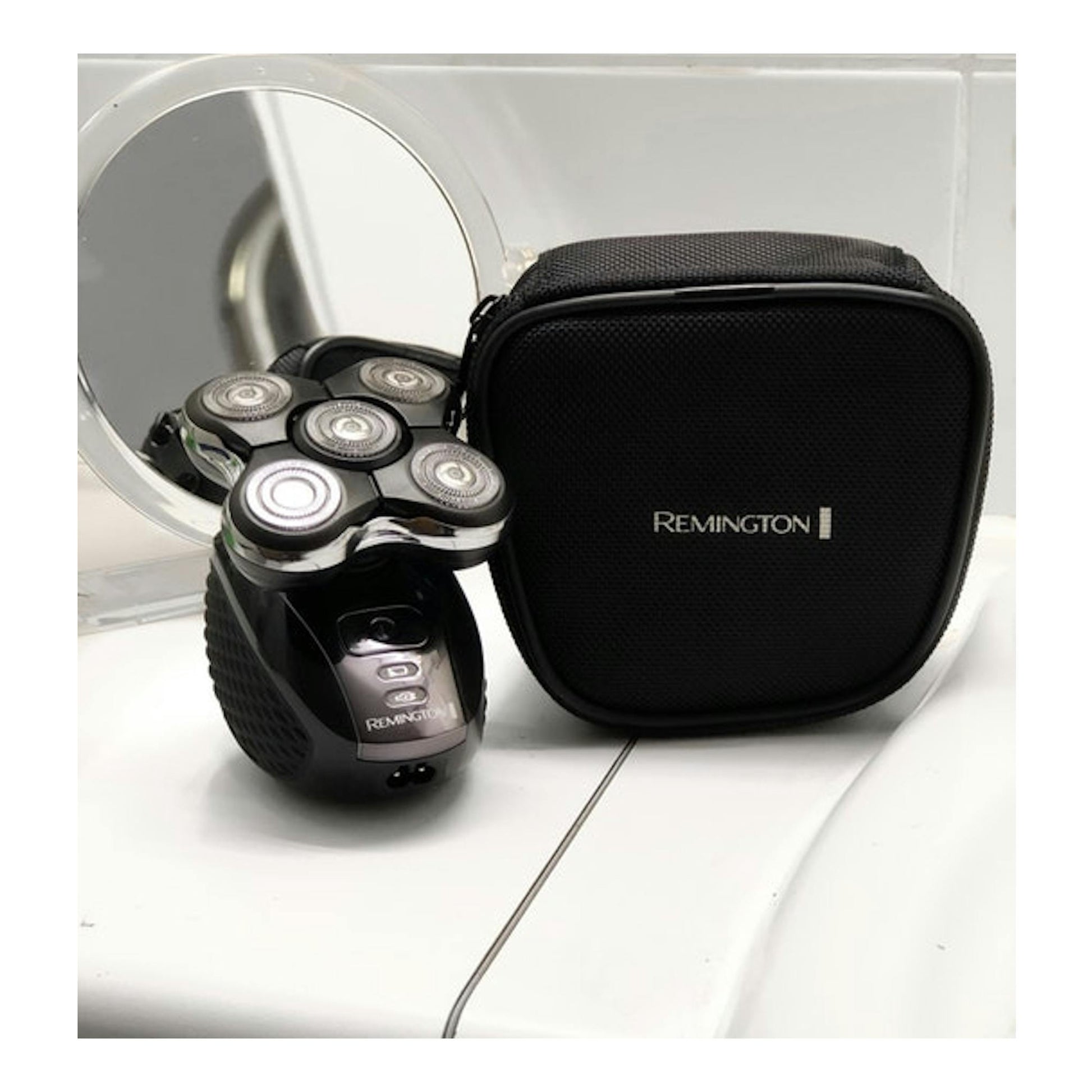 Afeitadora Remington Ultimate Series RX5 XR1500 negra, con 5 cabezales, junto a estuche y espejo.