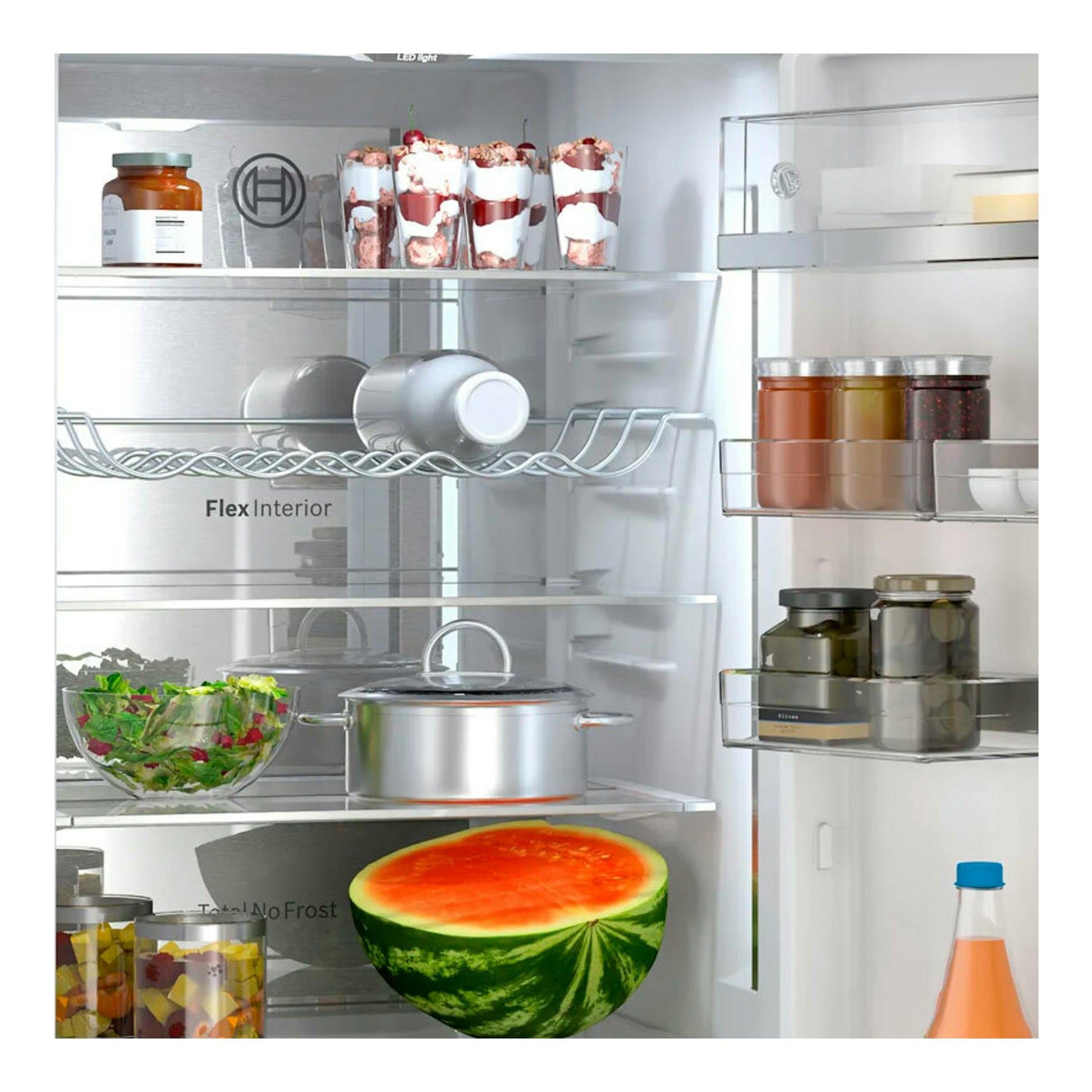 Interior de frigorífico combi Bosch KGN39AIAU inox, vista frontal, con estantes de cristal y balcones en la puerta.