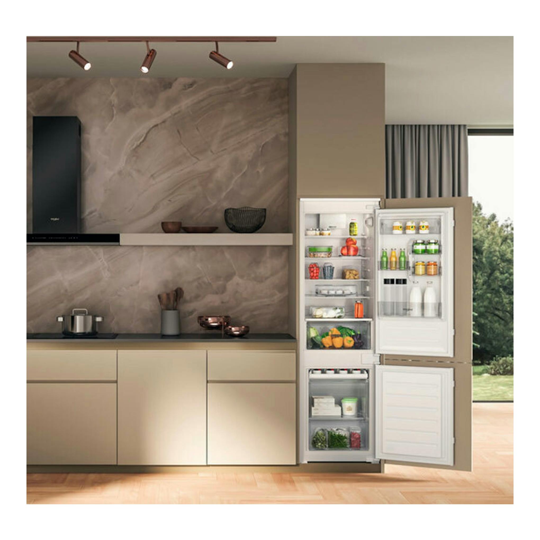 Frigorífico combi integrable Whirlpool WHC18D031A1, con puertas abiertas en cocina moderna.