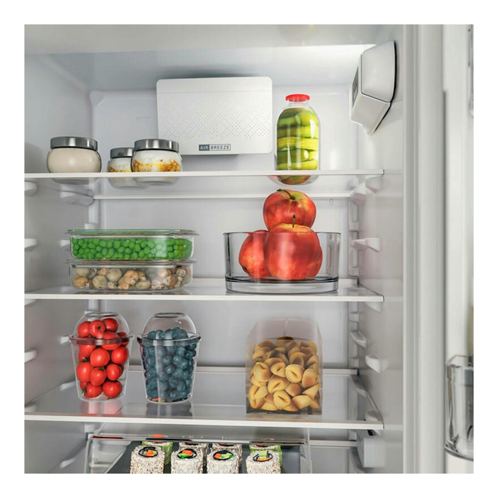 Interior de frigorífico combi integrable Whirlpool WHC18D031A1, con estantes y alimentos vistos de frente.