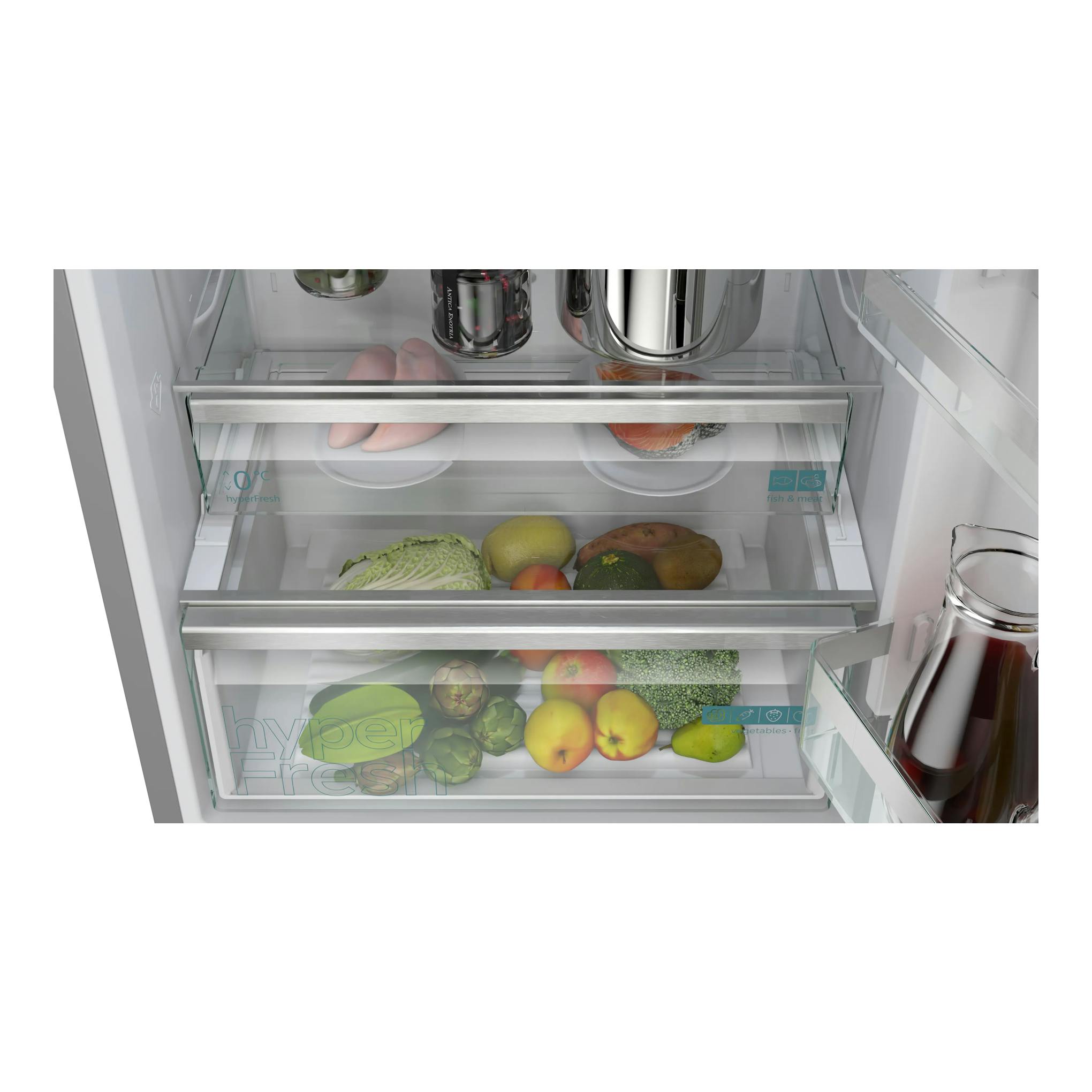 Frigorífico combi Siemens KG49NVIDG, interior en vista frontal con cajones de vidrio y alimentos.