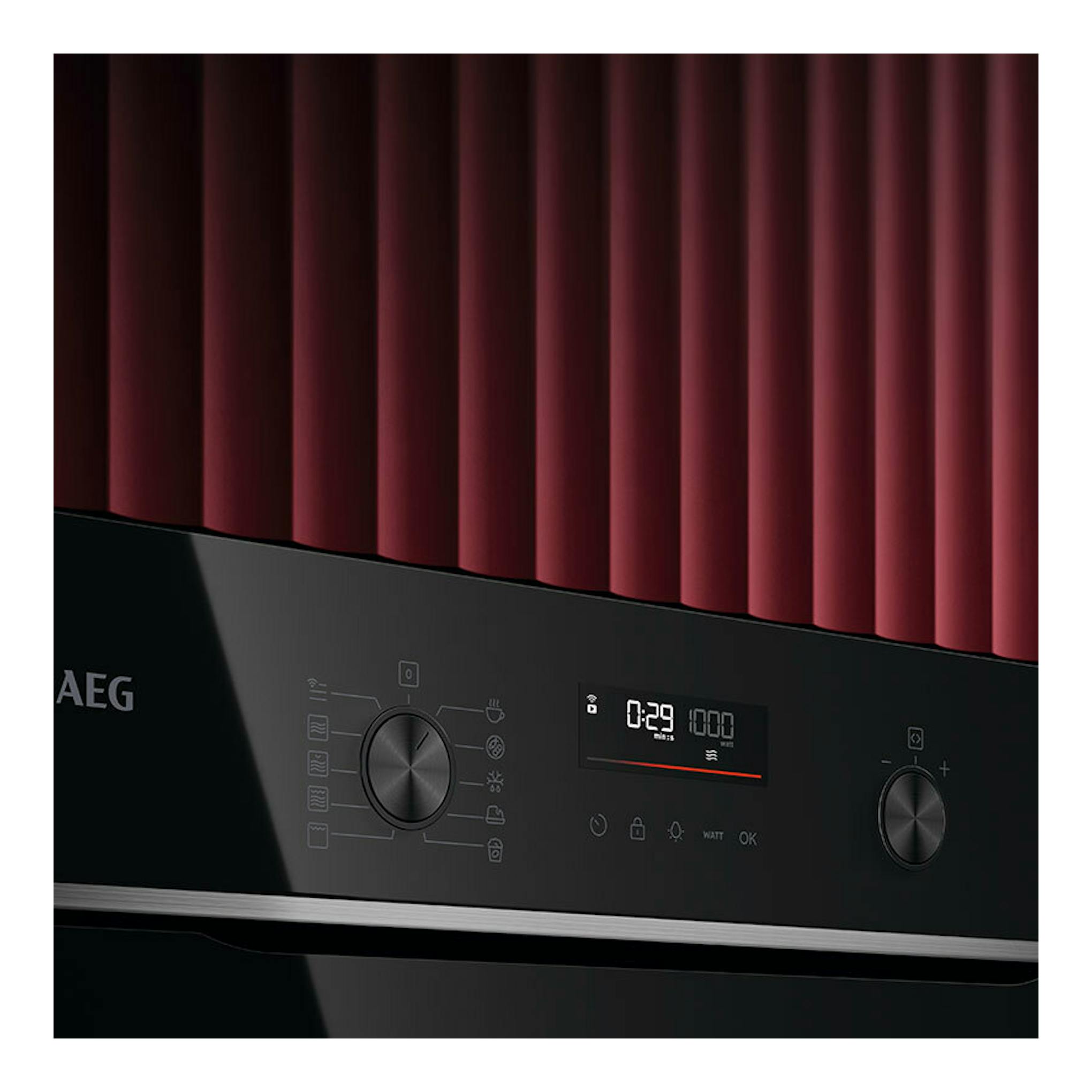 Microondas integrable AEG TM5NK401B negro, vista frontal parcial con pantalla digital y dos mandos.