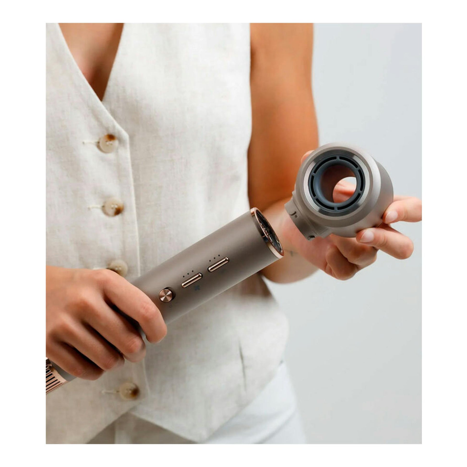 Moldeador de pelo Taurus Airwave Digital Pro en color gris, sujetado por una persona con el cabezal desmontado.