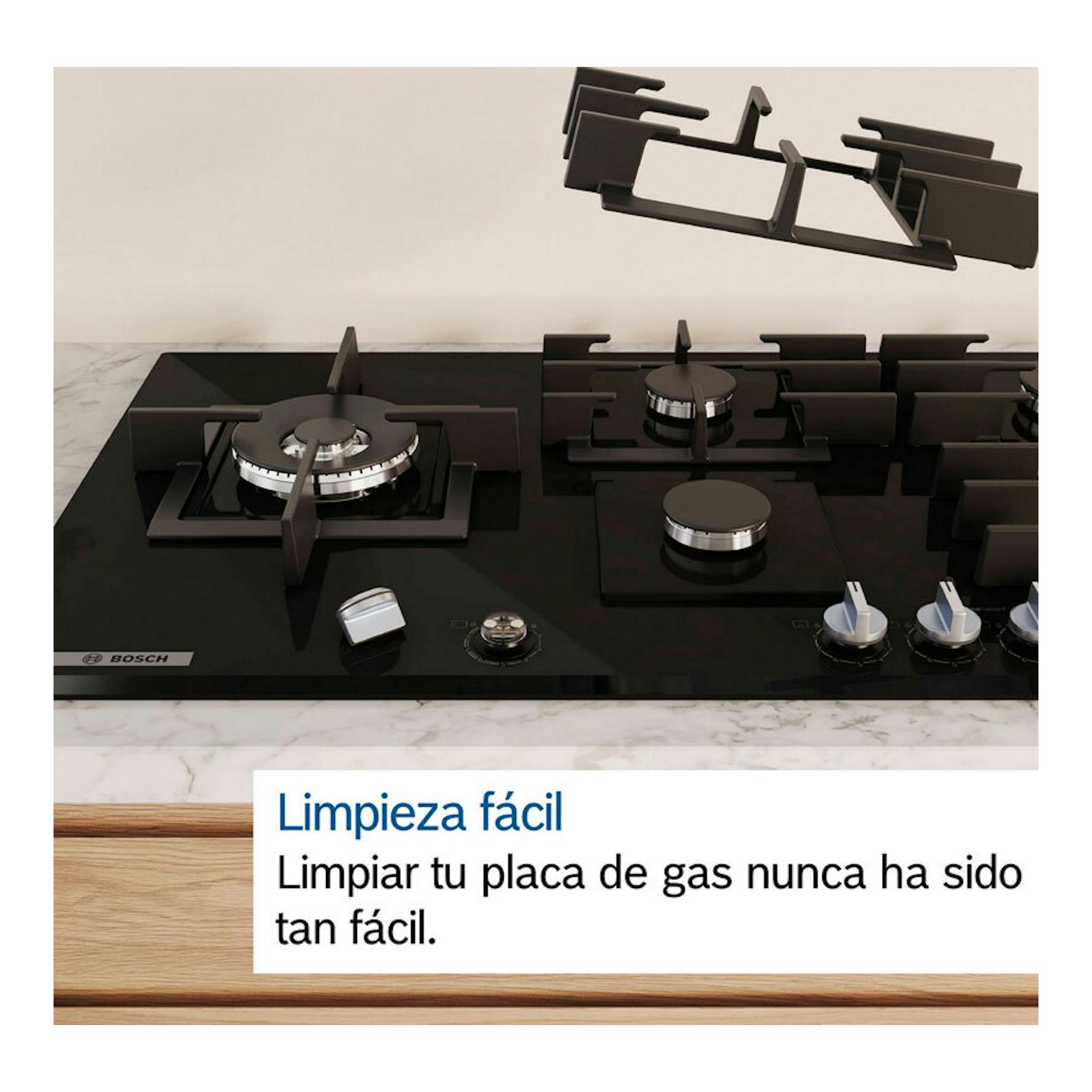 Placa de gas Bosch PCC6A5I90 de 60 cm, negra, vista frontal, con cuatro quemadores y parrillas desmontadas.